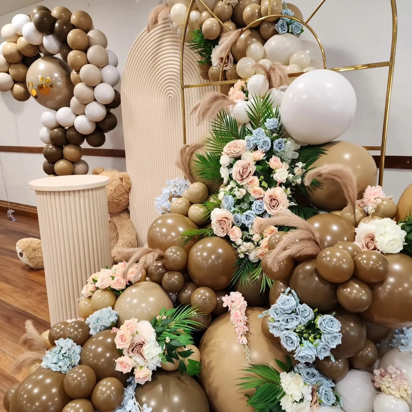 Neutral balloon garland with blush and blue faux florals and pampas grass