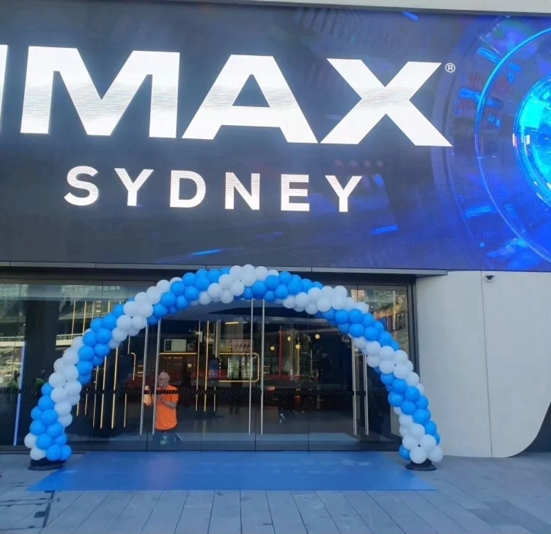 Blue and white balloon arch over the entrance of a corporate event venue in Sydney