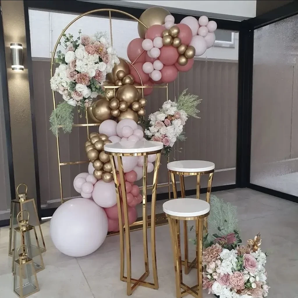 Pink and gold floral garland with plinths by JM Balloons and Beyond