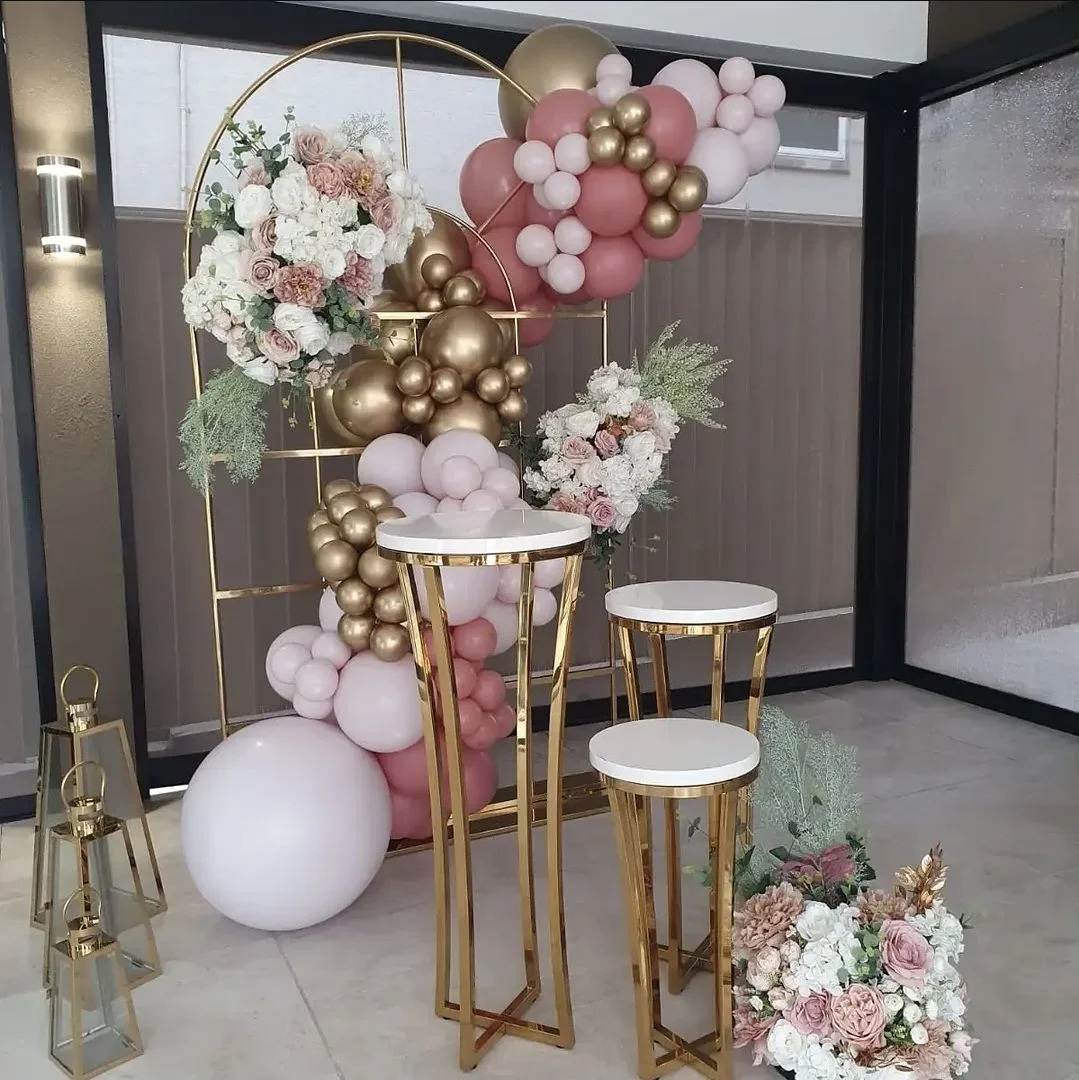 Pink and gold balloon garland with faux florals and gold plinths