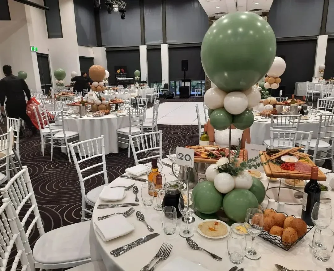 Sage and white balloon table centrepieces at a Sydney function venue
